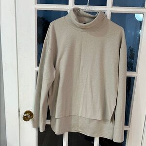 28.    Women's Cream Turtleneck Sweater